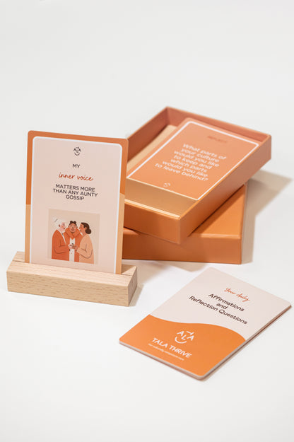 Tala Thrive Cultural Affirmation and Conversation Cards deck with wooden stand on neutral background. Aunty gossip